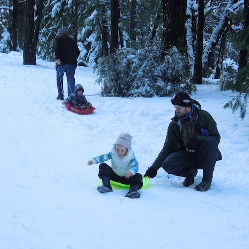 Sledding in the snow of the Sierra Nevada Mountains